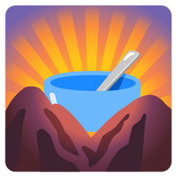 bowl with spoon and sunrise over mountains