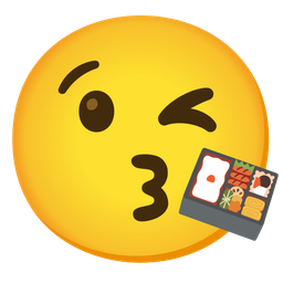 face blowing a kiss and bento box