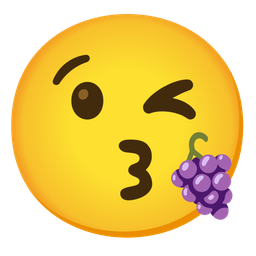 face blowing a kiss and grapes