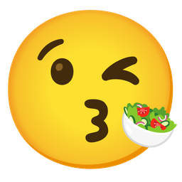 face blowing a kiss and green salad