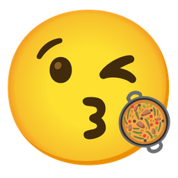 face blowing a kiss and shallow pan of food