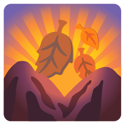 fallen leaf and sunrise over mountains