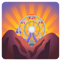 ferris wheel and sunrise over mountains