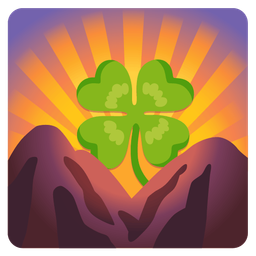 four leaf clover and sunrise over mountains