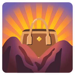 handbag and sunrise over mountains