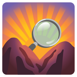 magnifying glass tilted right and sunrise over mountains