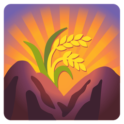 sheaf of rice and sunrise over mountains