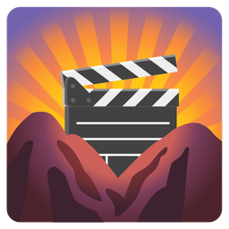 sunrise over mountains and clapper board