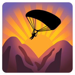 sunrise over mountains and parachute