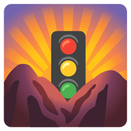 vertical traffic light and sunrise over mountains